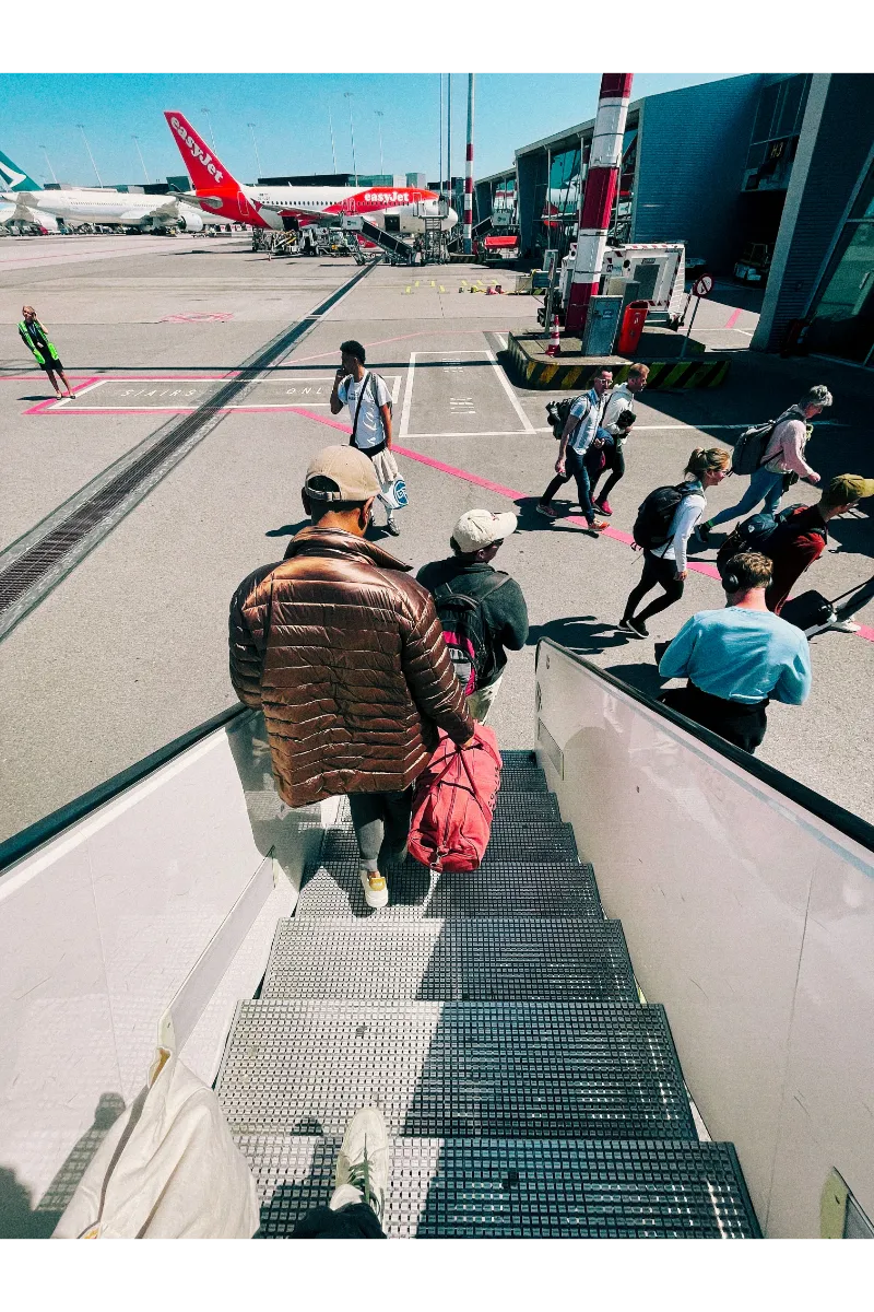 How to Travel Europe Cheaply - a person coming out of an airplane.