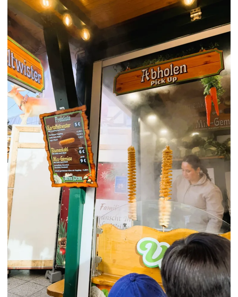 Crispy spiral potato twister on a stick at the Frankfurt Christmas Market, a fun crunchy snack loved by visitors.