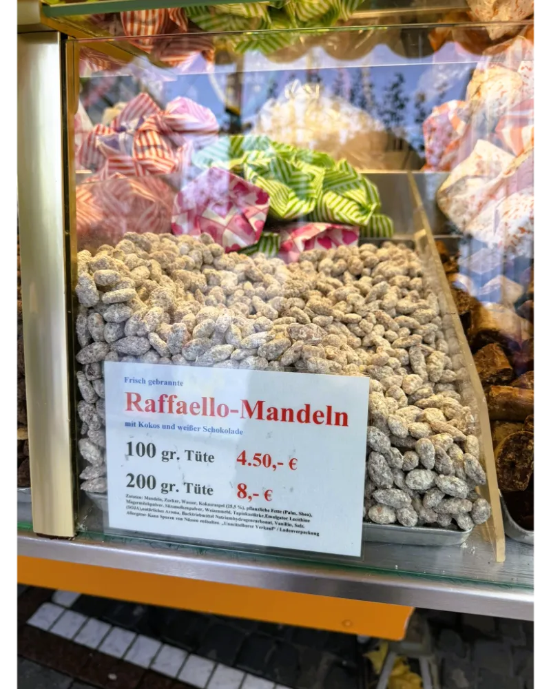 Warm roasted almonds coated in caramelized sugar at the Frankfurt Christmas Market — a must-try festive sweet.