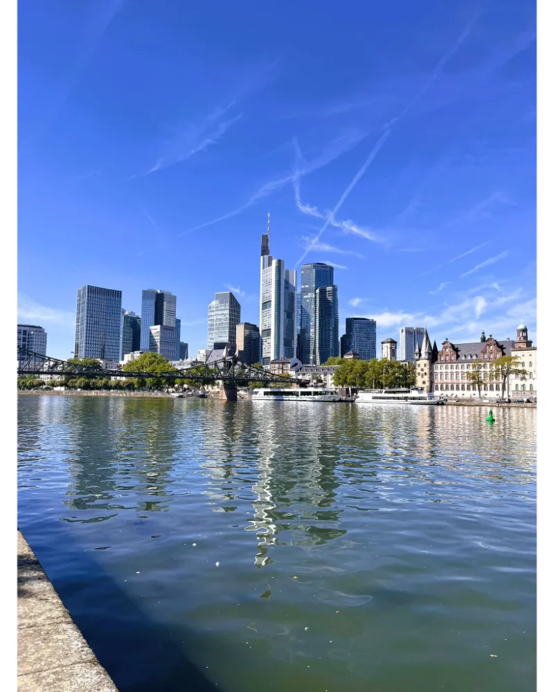 Frankfurt skyline reflected in the Main River, showing the city’s modern architecture.
